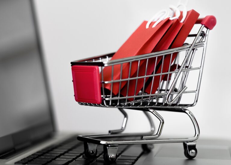 front-view-laptop-with-shopping-cart-bags-cyber-monday