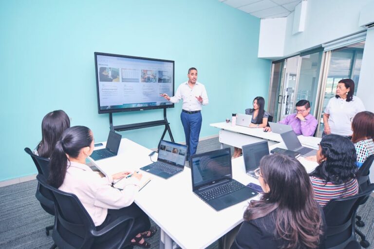Team engaged in a presentation at a modern office using digital technology.